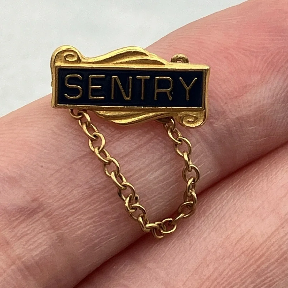 Vintage Sentry Insurance Gold Tone Black Enamel Lapel Pin Tie Tack Safety Chain